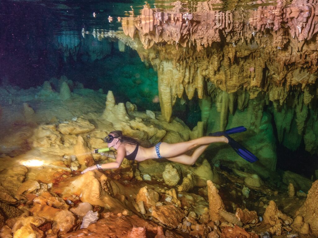 woman diving in cave