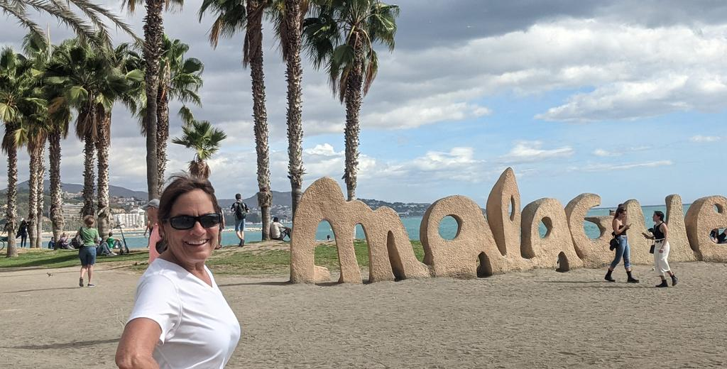 Donna in front of Malaga beach sign